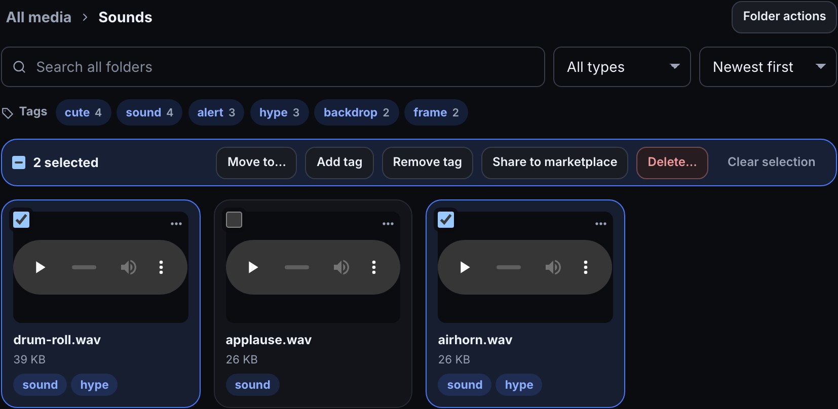 The Sounds folder with drum-roll.wav and airhorn.wav ticked and applause.wav not: the bar above the files reads 2 selected with Move to…, Add tag, Remove tag, Share to marketplace, Delete… and Clear selection.